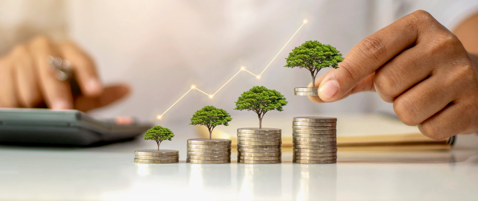 A a pile of coin with a miniture house of a tree on top of a pile of coin