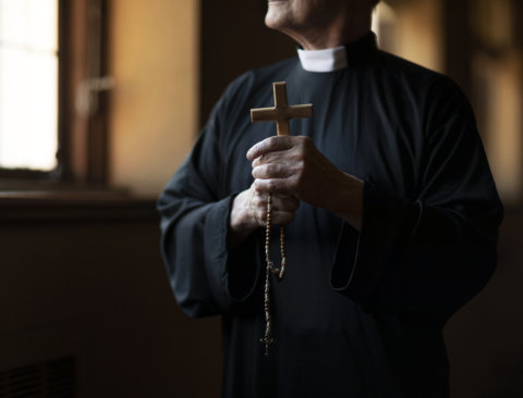 A man holding a cross