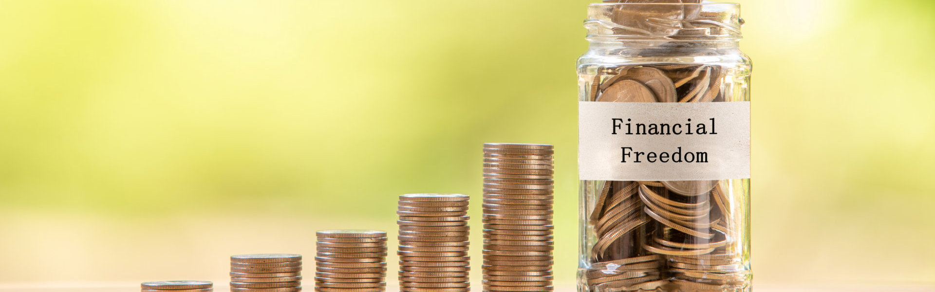 A pile of coins and coins inside the jar